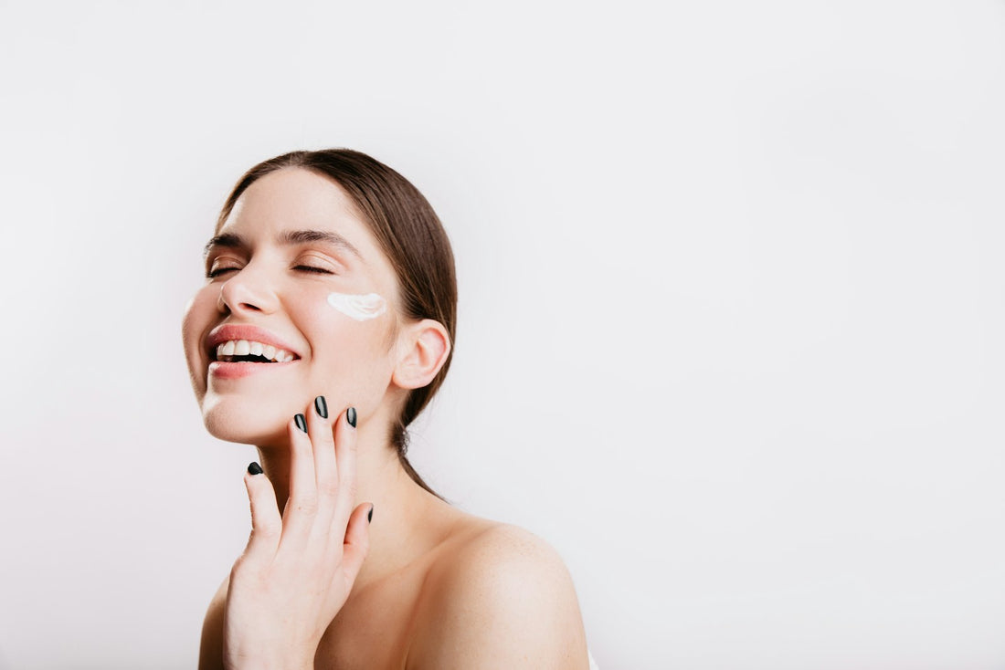 Femme souriante, la main posée sur son visage