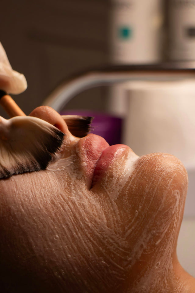 Application d'un soin au pinceau sur le visage