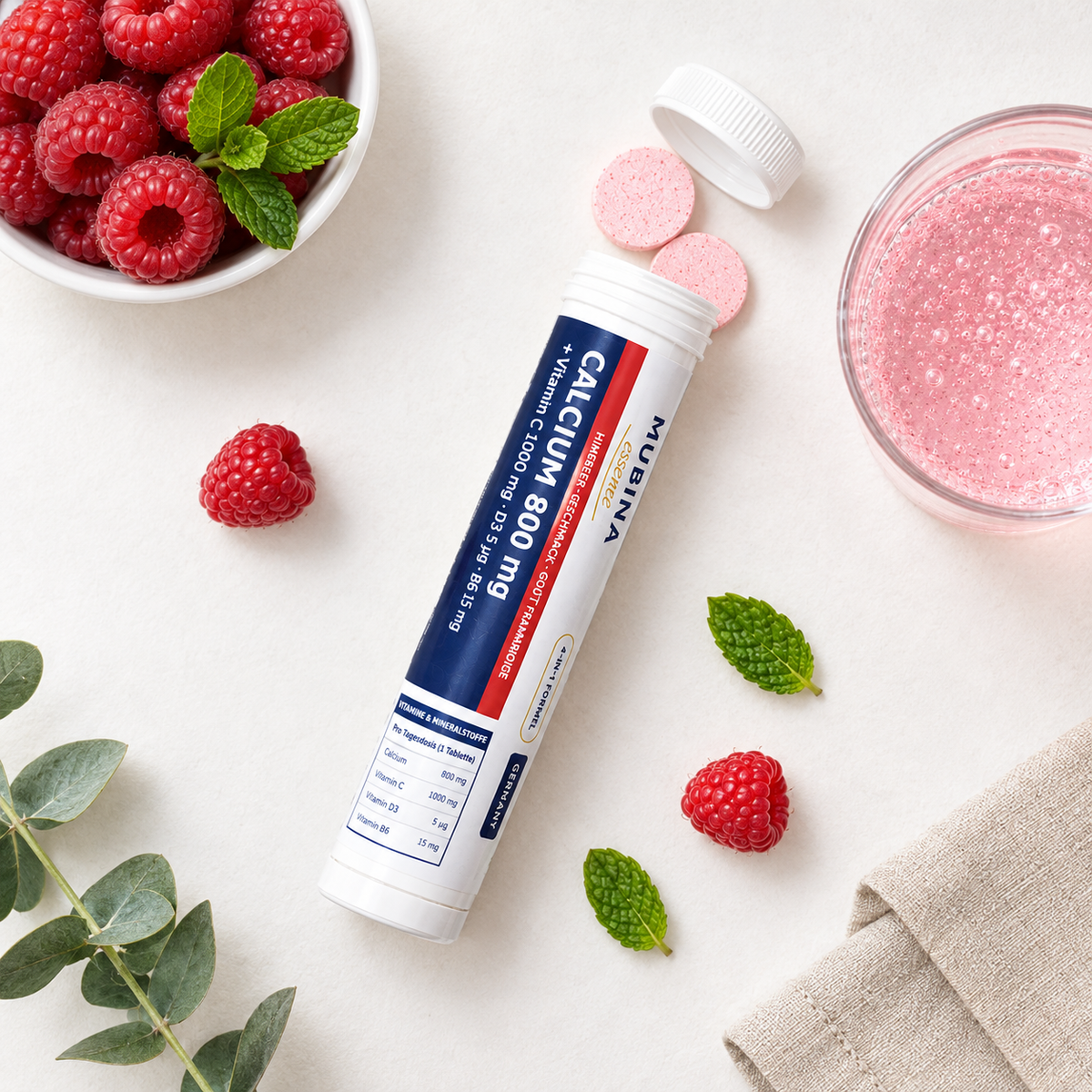 Mubina Calcium 800 mg vu de dessus avec comprimés effervescents, framboises et menthe